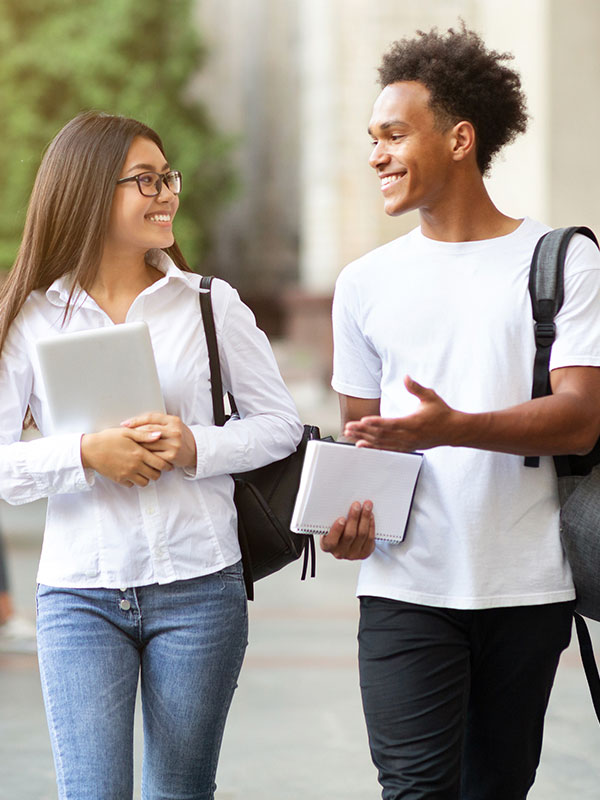 Two college students walk to class